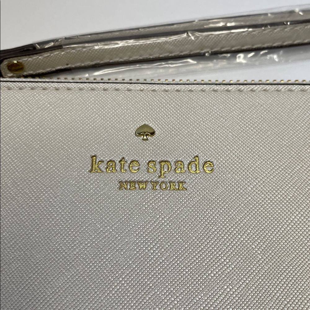 NWT Kate Spade cream saffiano wristlet with gold logo.  8x5” - Picture 2 of 7
